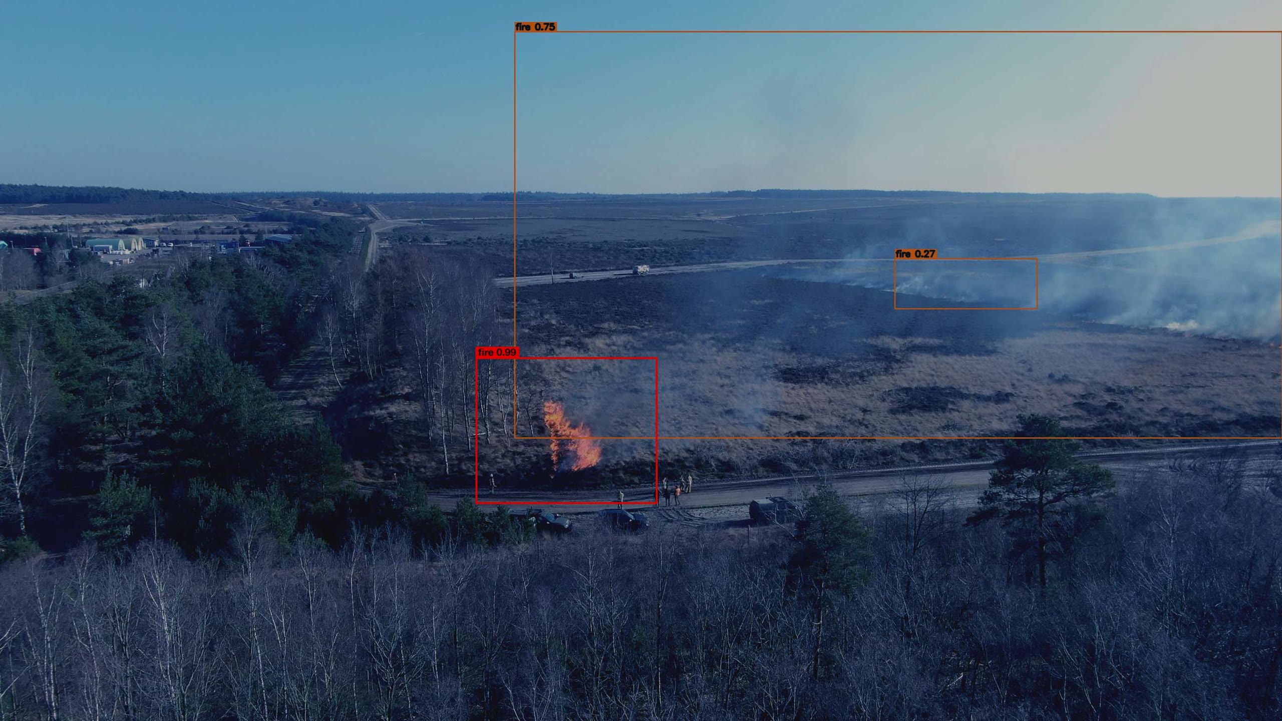 Aerial view of an early heath fire with Lucem detection boxes and confidence scores
